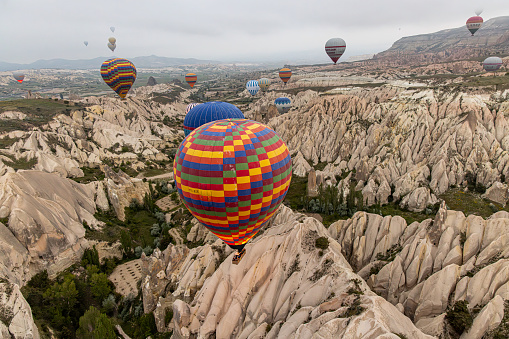 Colorful hot air balloon flying above the clouds