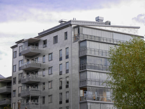 istock Low angle view of a modern building against cloudy sky 1559292564