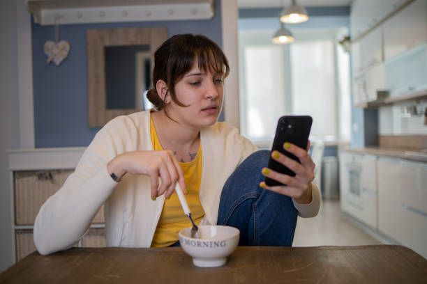 istock Happy young woman using phone at home 1559294614
