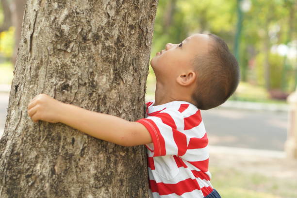 istock concept of saving the world boy hugging a tree 1559386264