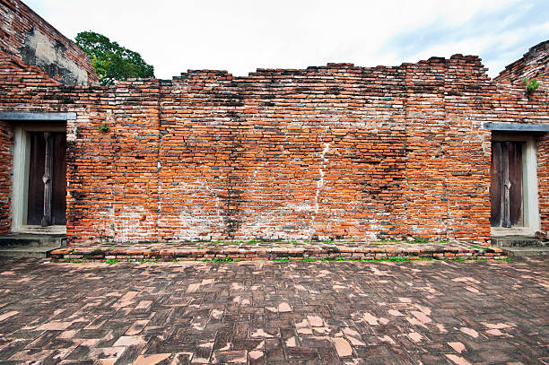 istock Old brick wall with two ancient wooden doors 155938957