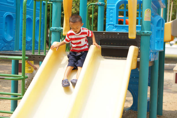 istock boy playing in the playground in the park 1559390555