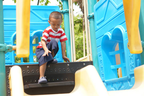 istock boy playing in the playground in the park 1559391930