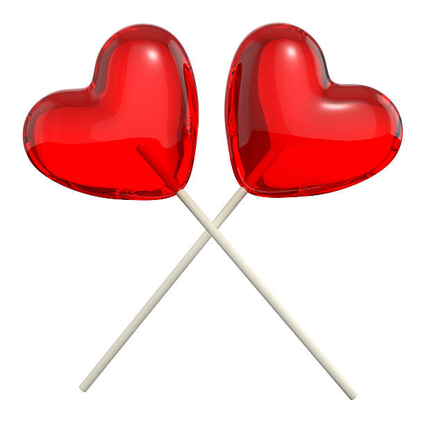 два перекрестные lollipops в форме сердца - flavored ice lollipop candy affectionate стоковые фото и изображения