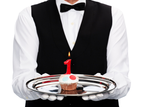 butler with cupcake with candle number one