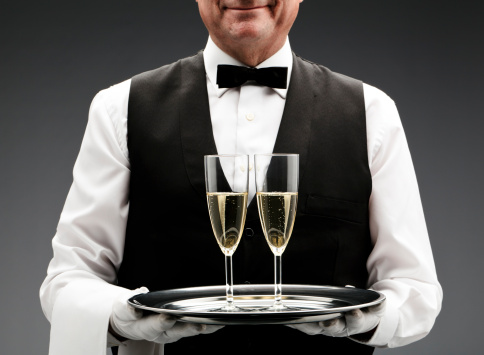 butler with two champagne flute on tray