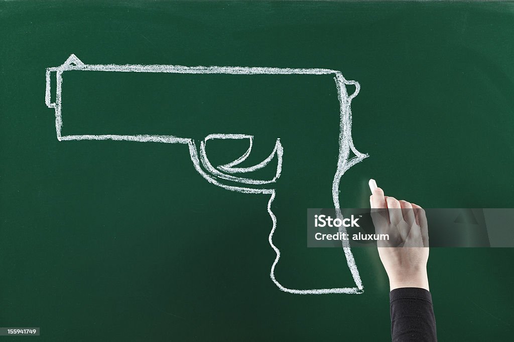 Gun on blackboard Drawing gun on blackboard Gun Stock Photo