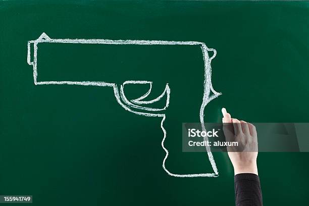 Gun On Blackboard Stock Photo - Download Image Now - Gun, Chalk Drawing, Chalk - Art Equipment