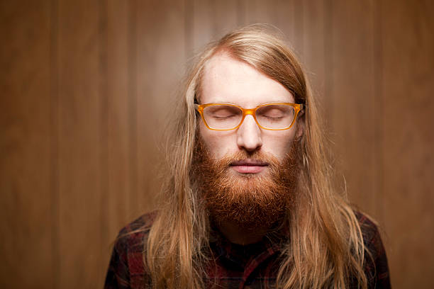 istock young bearded man with long hair closing his eyes 155943200