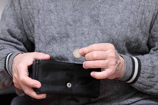 istock Old man with one Euro coin 155945406