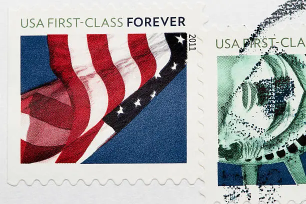 Stamp with United States of America flags. Postmarks stamps on a white envelope