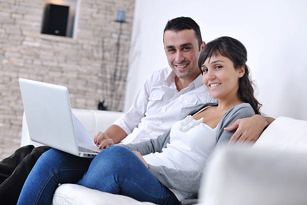 istock couple relax and work on laptop computer at modern home 155949174