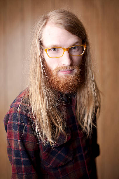 istock happy young man with a beard and long flowing hair 155949297