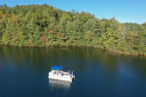 Aerial view of pontoon boat on Lake Santeetlah, North Carolina in autumn.