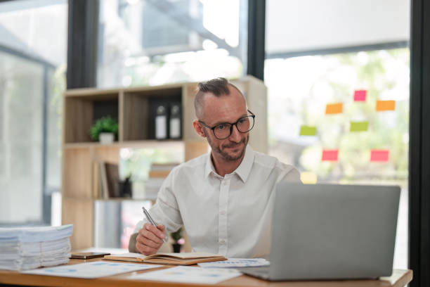 istock Business man working on project for analyzing company financial report balance statement with documents at modern office. business, economy, market, money and tax concept 1559514223