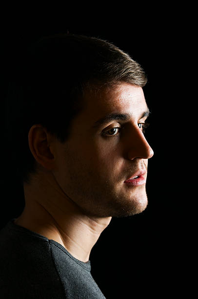 istock young man portrait on black 155951440