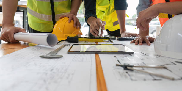 istock engineer team working in office with blueprints, inspection in workplace for architectural plan, construction project ,Business construction 1559519342