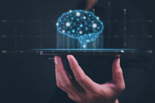 istock Brain representing artificial intelligence and businessman holding futuristic tablet for Artificial intelligence (AI), machine deep learning, data mining and another modern computer technology concept 1559519964