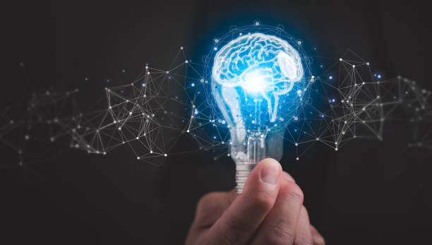 istock Creative thinking ideas and innovation concept with Businessman holding glowing lightbulb with drawing brain and connection line. 1559520470