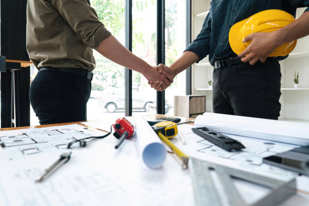 istock Engineer and contractor shaking hands success of the project work together 1559520976