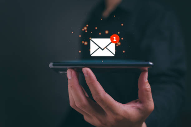 istock New email notification concept for business e-mail communication and digital marketing. Businessman holding mobile and inbox receiving electronic message alert. Internet technology. 1559522496