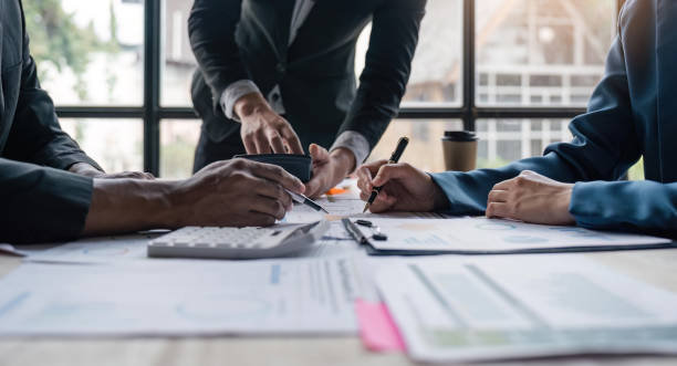 istock Business team analyzes financial business finance reports on laptop and graph documents during corporate meeting discussions showing successful teamwork, business meeting ideas 1559537131