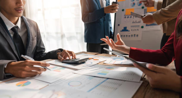 istock Business team analyzing income charts and graphs with modern laptop computer and digital tablet. Close up. Business analysis and strategy concept 1559540420