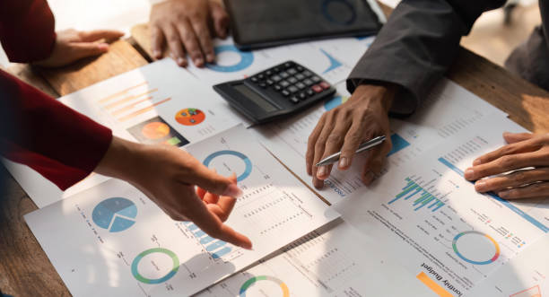 istock Business team analyzing income charts and graphs with modern laptop computer and digital tablet. Close up. Business analysis and strategy concept 1559540943