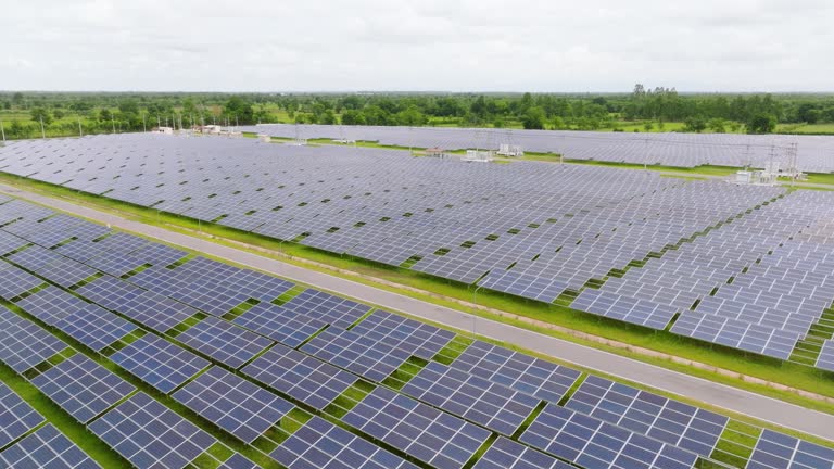 Aerial view of solar panel on green with sky background.