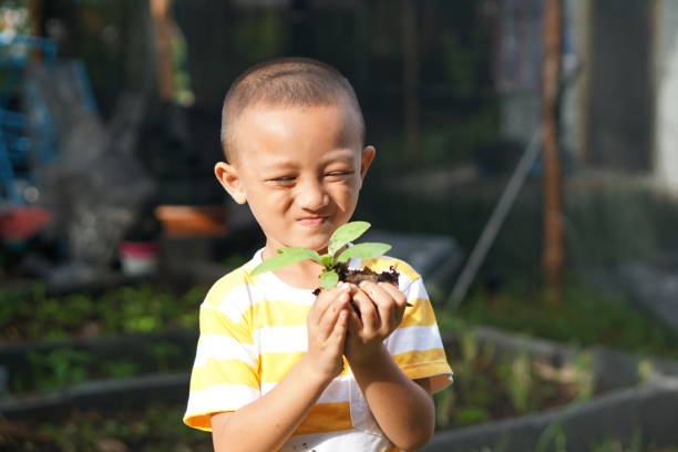 istock concept of saving the world boy planting trees 1559571867