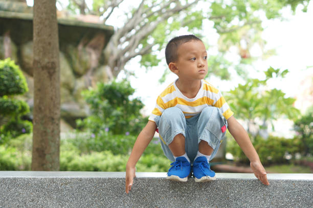 istock happy boy playing in the park 1559577418