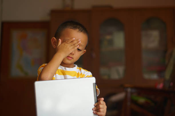 istock eye pain boy from looking at the computer 1559578501
