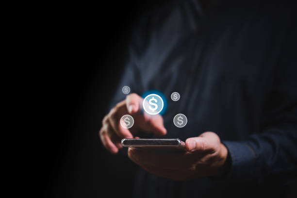istock Businessman hand holding smartphone and dollar icon 1559620765