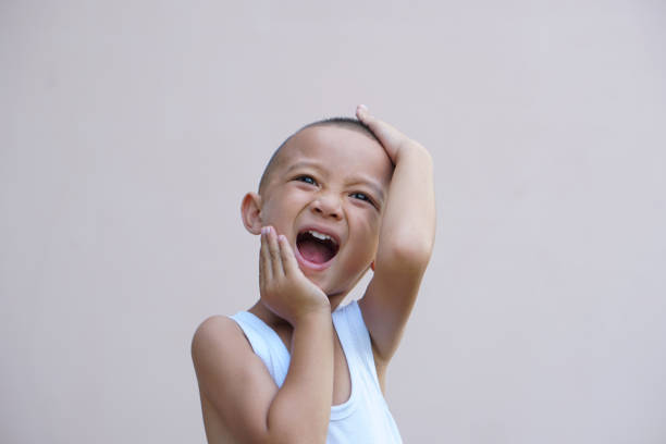 istock Asian boy smiling happily room wall background 1559636381