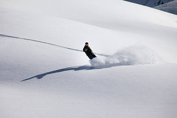 Snow boarder in fresh powder , New Zealand stock photo