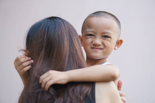 istock boy happily hugging his mother 1559639593
