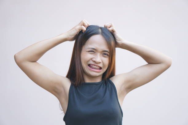 istock Asian woman having itchy head from dandruff 1559641717