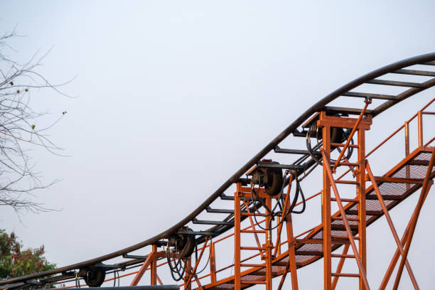 istock Steel track structure of roller coaster ride in amusement park on sky background. 1559649072