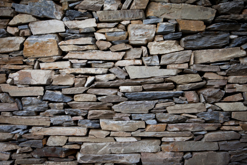Stones layered to form a wall in rural part of Nepal.