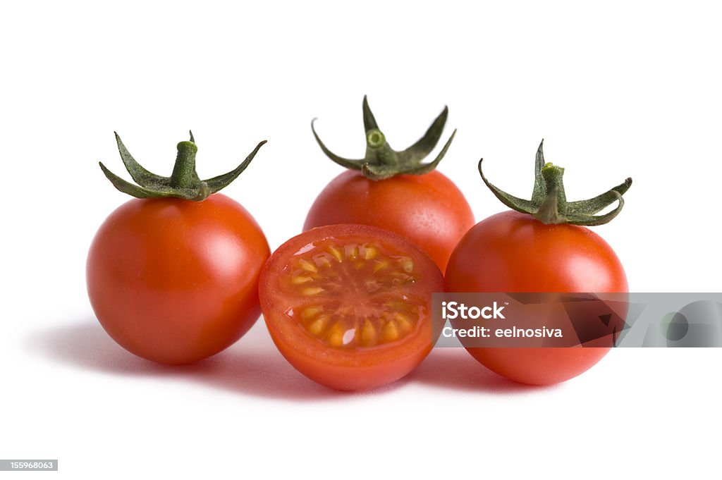 Arrangement of cherry tomatoes cherry tomatoes isolated with one tomato cut in half Cherry Colored Stock Photo