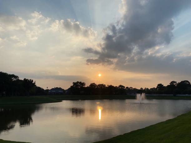 istock Tranquil lake at sunset, surrounded by a peaceful landscape 1559694652