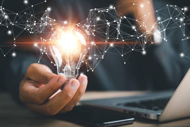 istock Businessman protects a glowing light bulb, symbolizing creativity and innovation 1559697903