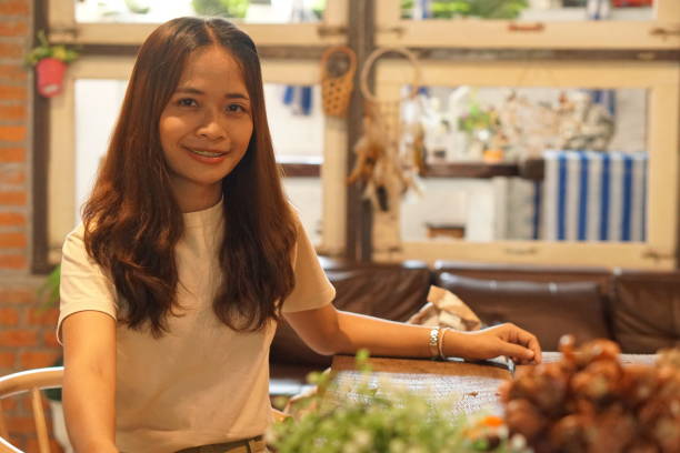 istock Asian woman smiling happily in a cafe 1559698411