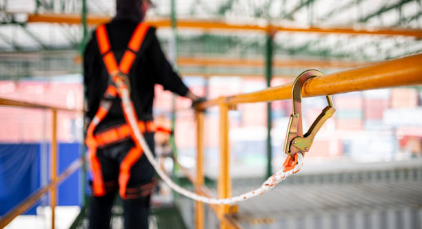 istock Construction worker wearing safety harness working at high place 1559699335