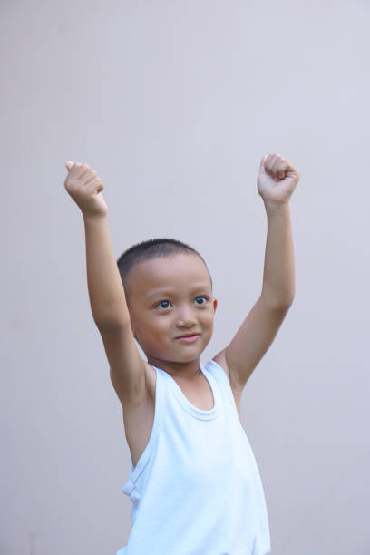 istock Asian boy smiling happily, gray background 1559701928