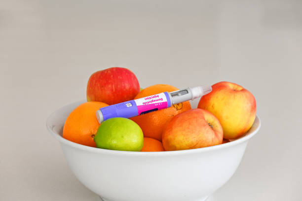 Semaglutide pen Semaglutide injection pen in a bowl of fruit wegovy stock pictures, royalty-free photos & images