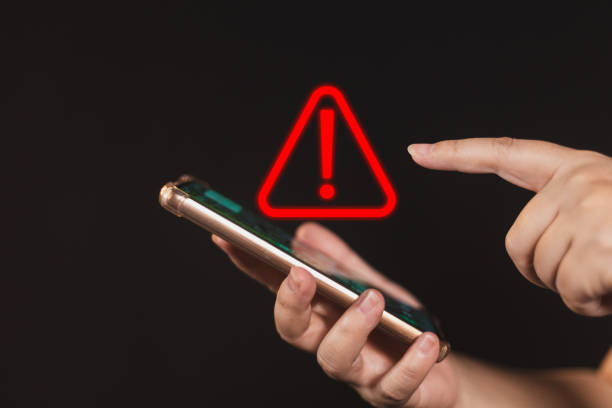istock woman using smartphone with notification error. warning sign over on mobile phone. maintenance connection application. programmer, developer. security network dangerous. 1559702219