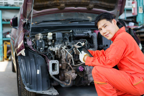 istock Vehicle technician repairing a broken car. 1559720668