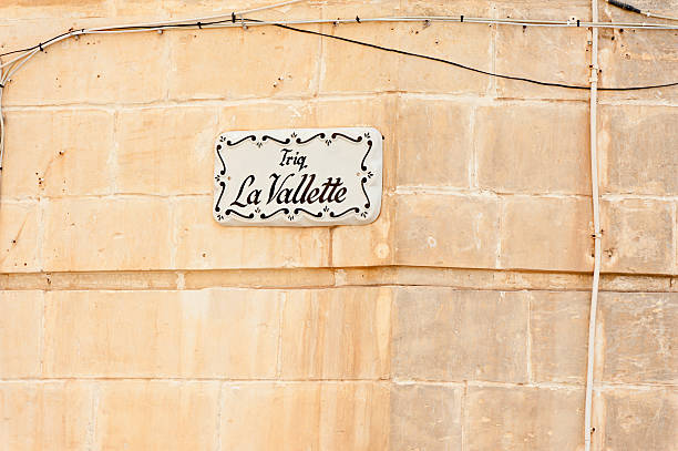 Street sign against wall in Birgu, Malta, Europe. Triq is Maltese for street.