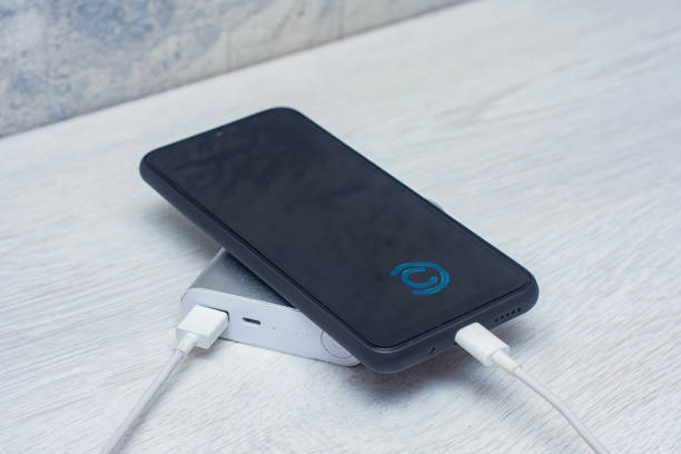 istock The smartphone is being charged using a portable charger on a wooden table. 1559805304